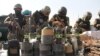 Afghan National Directorate of Security officers display weapons and ammunition seized during operations against Taliban militants, in Helmand on February 18. The UN says that violence in Afghanistan has increased in recent months.