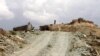 An Afghan soldier stands guard as soldiers prepare for an operation to recapture a military base from the Taliban in Ghazni Province on May 2.