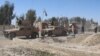 Afghan security forces patrol the outskirts of Helmand.