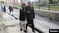 People flee the area after a bomb attack at Kabul's Khalifa Sahib Mosque on April 29. 
