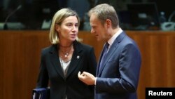  EU foreign policy chief Federica Mogherini talks to European Council President Donald Tusk during an EU leaders summit in Brussels, December 18.