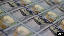 Dollars-US Debt-WASHINGTON, DC - MAY 20: Newly redesigned $100 notes lay in stacks at the Bureau of Engraving and Printing on May 20, 2013 in Washington, DC. 