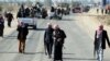 Armed relatives and tribe members protect the road during a funeral procession for deputy Ayfan Saadun al-Essawi of the Al-Iraqiyah bloc in the western town of Fallujah on January 16. Essawi was killed by a suicide bomber.