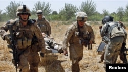 U.S. Marines carry a wounded comrade to a waiting medevac helicopter near the town of Marjah in Helmand Province.