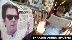 A newspaper bears news of the controversial victory of Imran Khan's Pakistan Tehrik-e Insaf party in the July 25 vote.