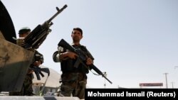 Afghan National Army (ANA) soldiers keep watch at a checkpoint on the Ghazni - Kabul highway on August 14.