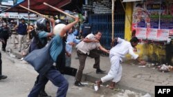 Bangladeshi police baton-charge Islamists during clashes in Dhaka on May 5. Opposition groups claim hundreds of Hefazat supporters have disappeared since.