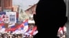 An ethnic Serbian boy looks at people demonstrating against the accord on the normalization of relations between Serbia and Kosovo in the ethnically divided town of Mitrovica on April 22.